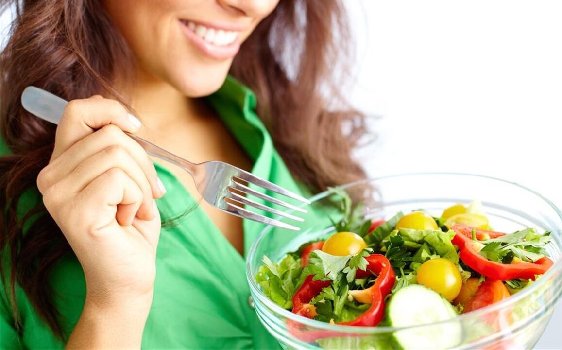 A girl eating a vegetable salad on a 6-petal diet